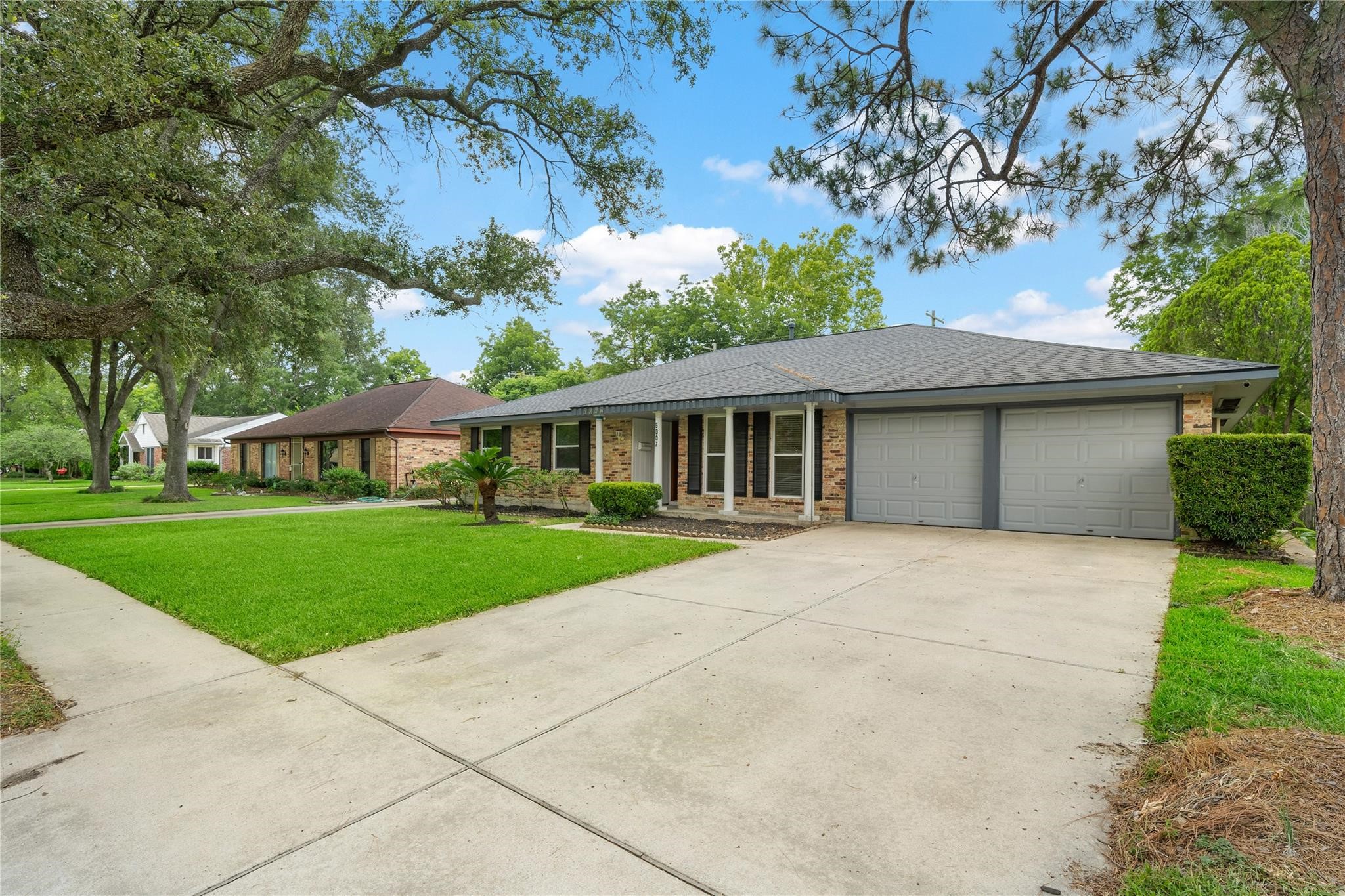 6007 Claridge Drive Houston, TX 77096 - Photo 23 of 38 a front view of a house with a yard