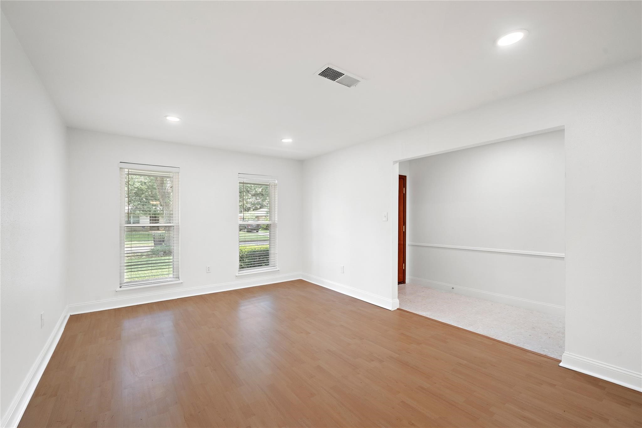 6007 Claridge Drive Houston, TX 77096 - Photo 28 of 38 an empty room with wooden floor and windows