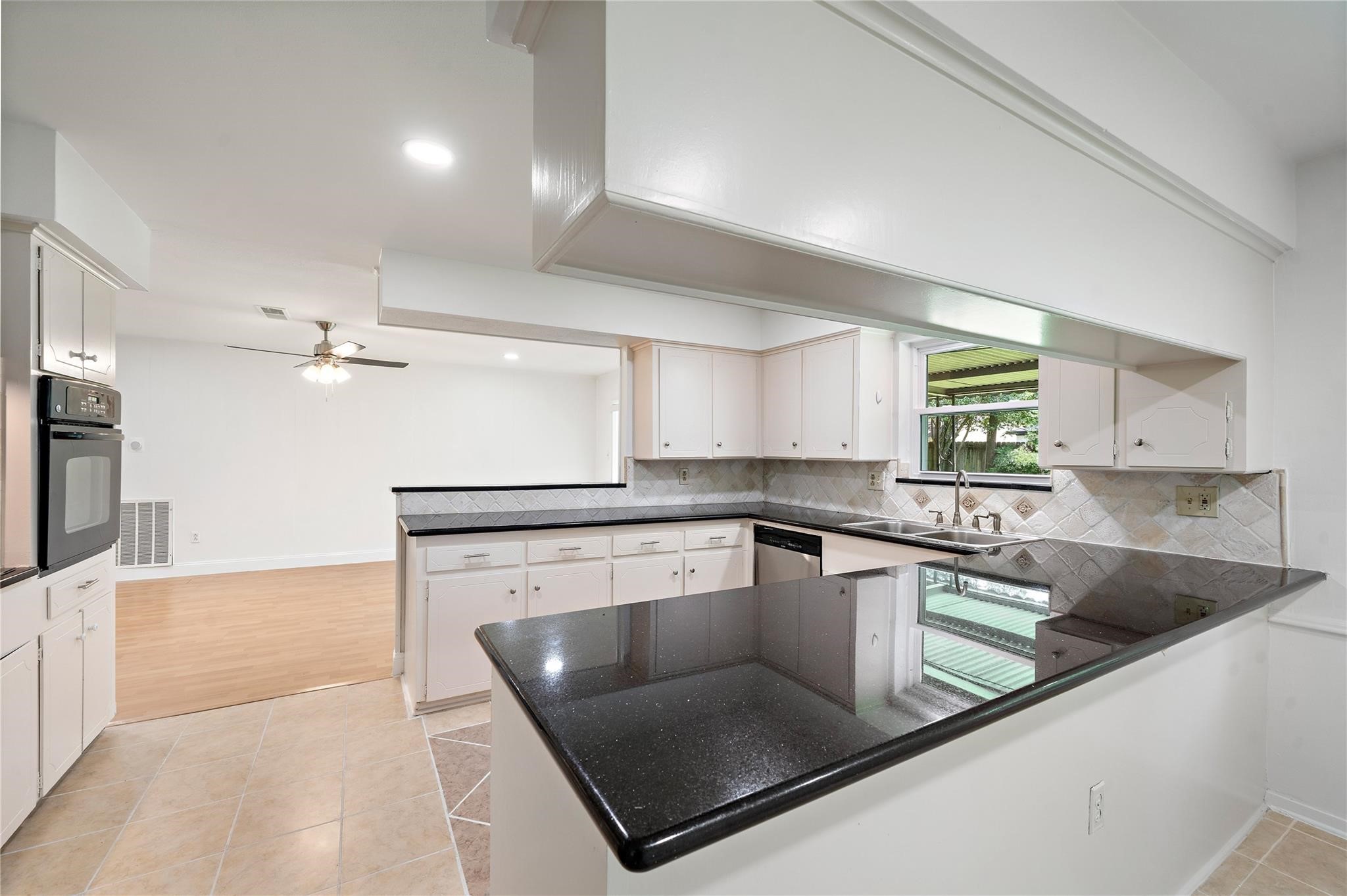 6007 Claridge Drive Houston, TX 77096 - Photo 33 of 38 a kitchen with stainless steel appliances granite countertop a sink a stove and a refrigerator