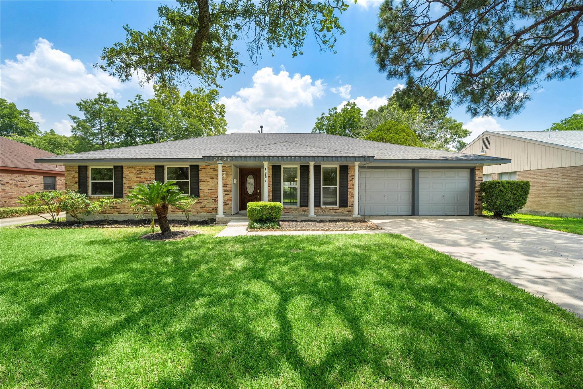 6007 Claridge Drive Houston, TX 77096 - Photo 37 of 38 a front view of house with yard and green space