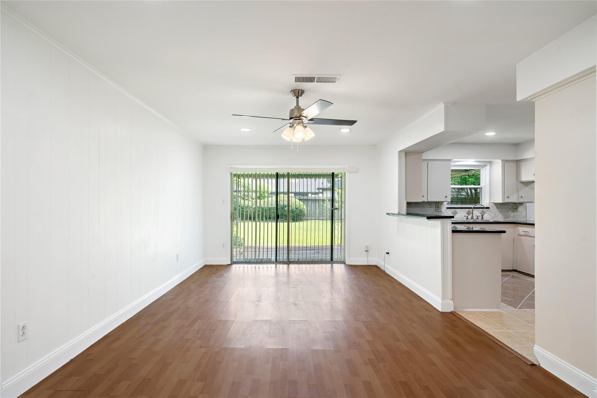 6007 Claridge Drive Houston, TX 77096 - Photo 9 of 38 an empty room with wooden floor and windows