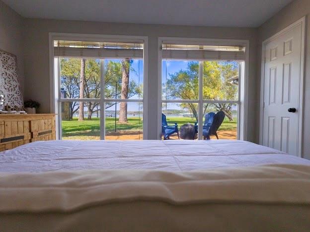 1957 Deer Trail Road Graford, TX 76449 - Photo 18 of 32 a bedroom with a bed and a large window