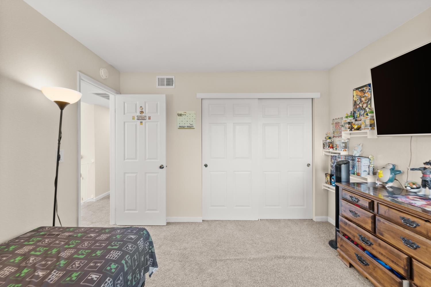 5861 Muldrow Road Sacramento, CA 95841 - Photo 23 of 38 a bedroom with a bed and a flat screen tv
