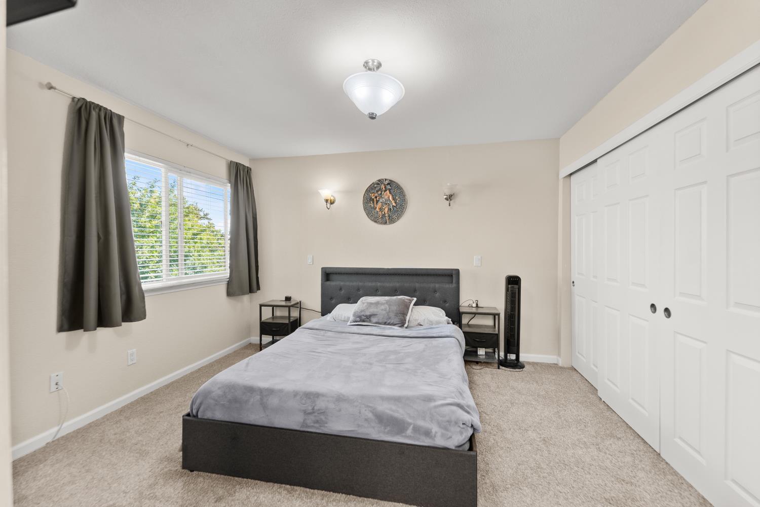 5861 Muldrow Road Sacramento, CA 95841 - Photo 26 of 38 a bedroom with a bed and a window