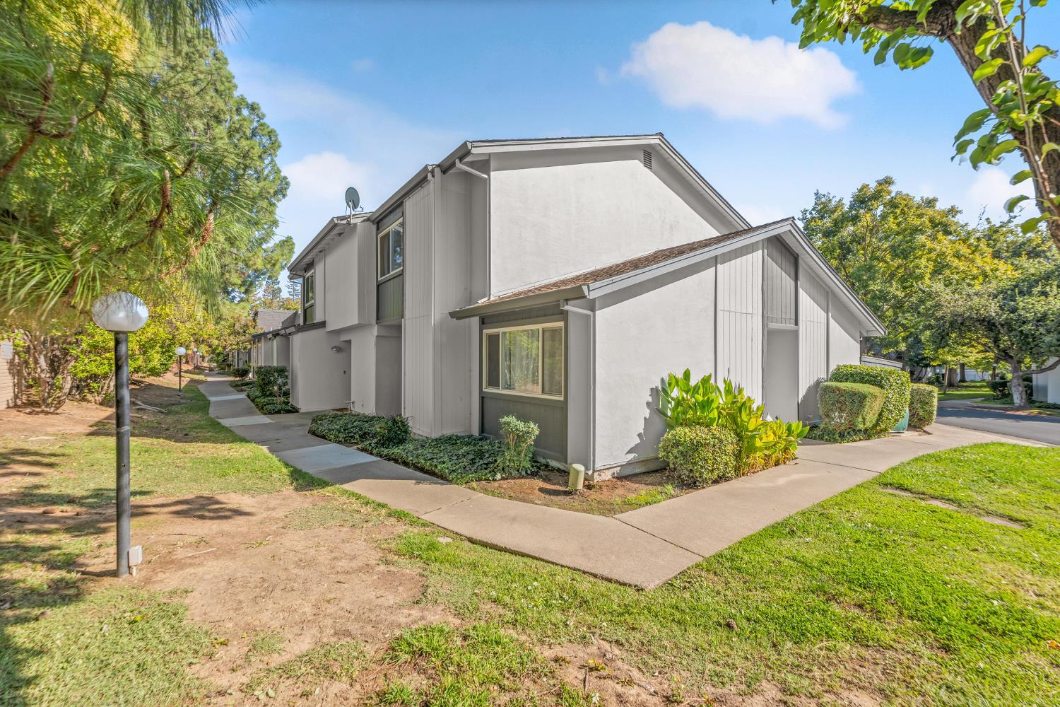 5861 Muldrow Road Sacramento, CA 95841 - Photo 3 of 38 a view of a white house next to a yard with potted plants