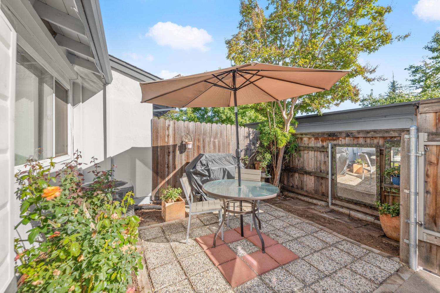 5861 Muldrow Road Sacramento, CA 95841 - Photo 32 of 38 a view of a patio with table and chairs under an umbrella