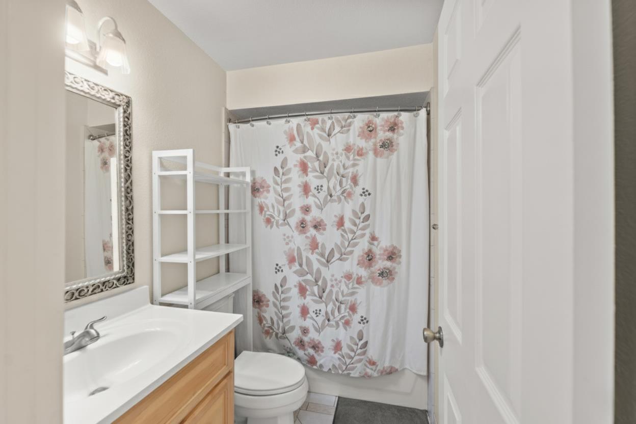 5861 Muldrow Road Sacramento, CA 95841 - Photo 8 of 38 a bathroom with a toilet a sink and a shower