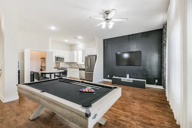 a kitchen with stainless steel appliances a stove a sink and a refrigerator