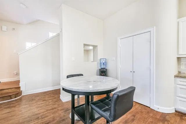 a view of a room with furniture and wooden floor