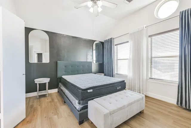 a bedroom with a bed and a chandelier