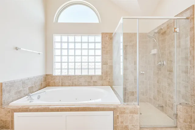 a bathroom with a bathtub and a shower