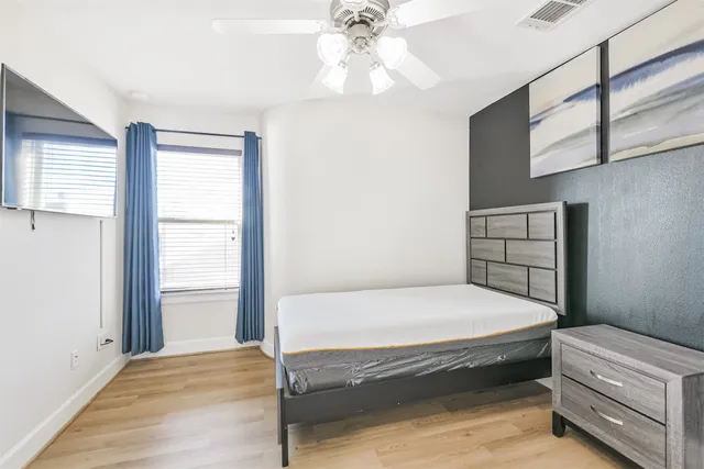 a bedroom with a bed and a window