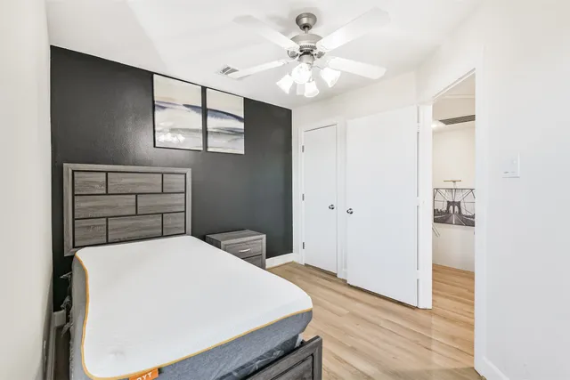 a bedroom with a bed and a chandelier