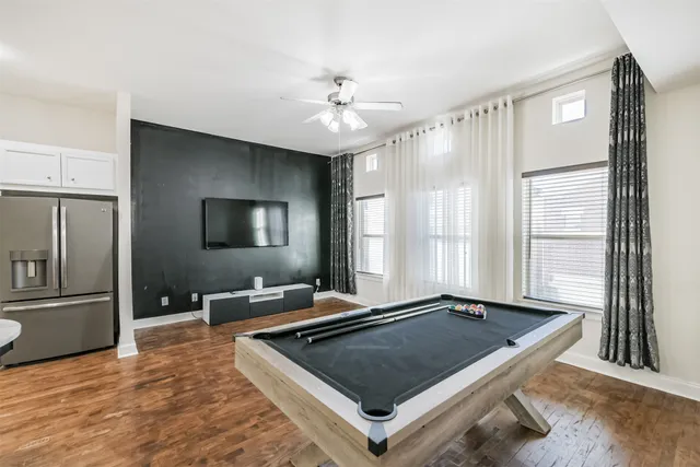 a room with pool table and windows