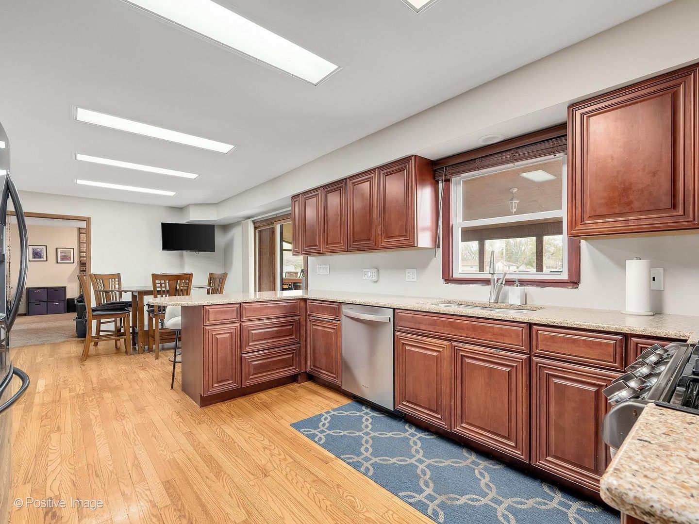 612 Stuart Drive Carol Stream, IL 60188 - Photo 11 of 29 a kitchen with stainless steel appliances granite countertop wooden cabinets a dining table and chairs