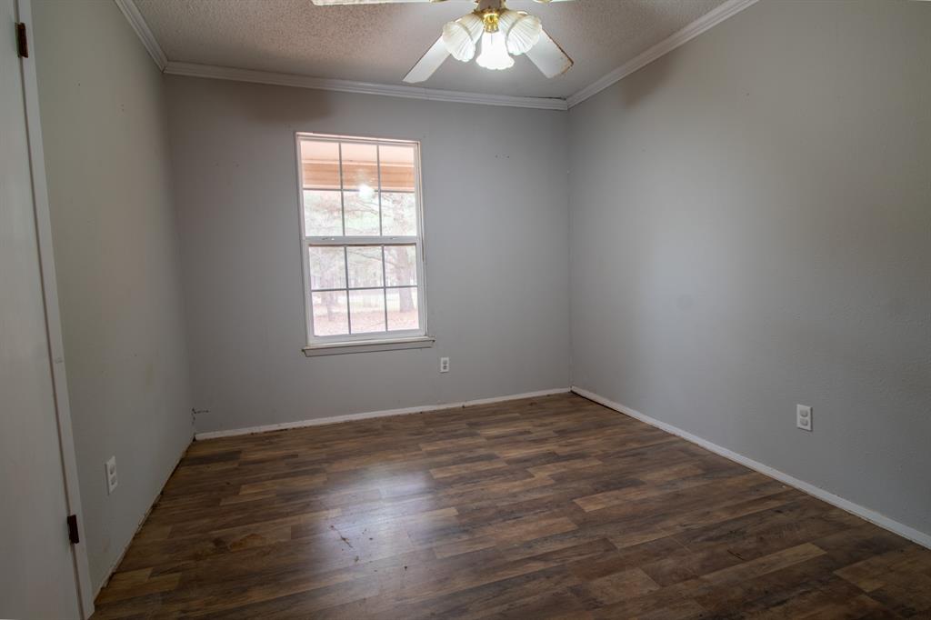 1088 Pheasant Road Gladewater, TX 75647 - Photo 14 of 31 an empty room with wooden floor and windows