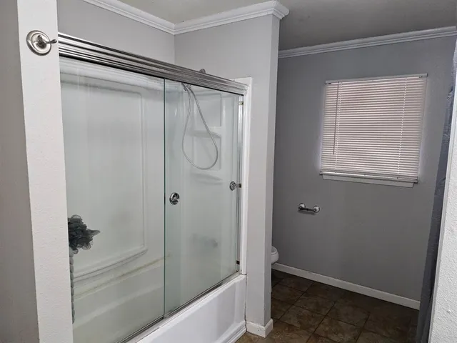 a bathroom with a glass shower door