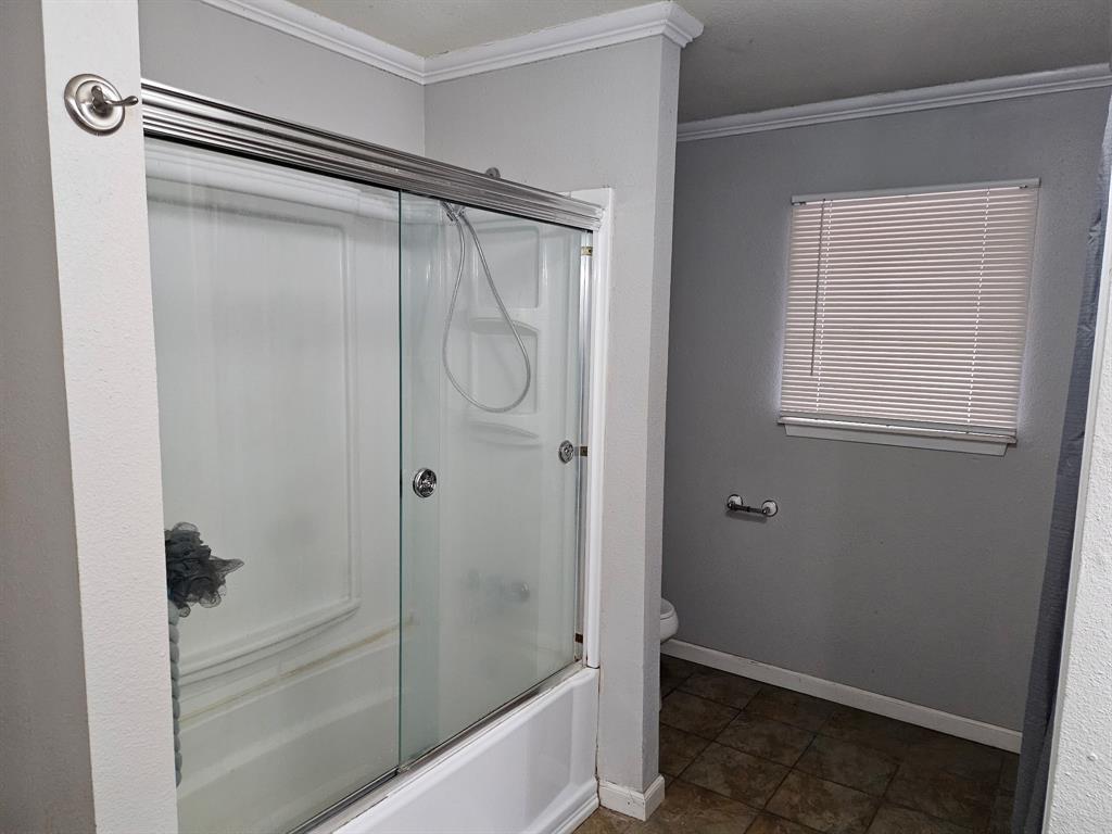 1088 Pheasant Road Gladewater, TX 75647 - Photo 20 of 31 a bathroom with a glass shower door