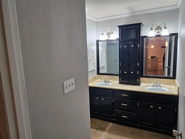 a bathroom with a double vanity sink and mirror