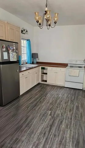 a kitchen with stainless steel appliances granite countertop a dishwasher a stove with wooden floor