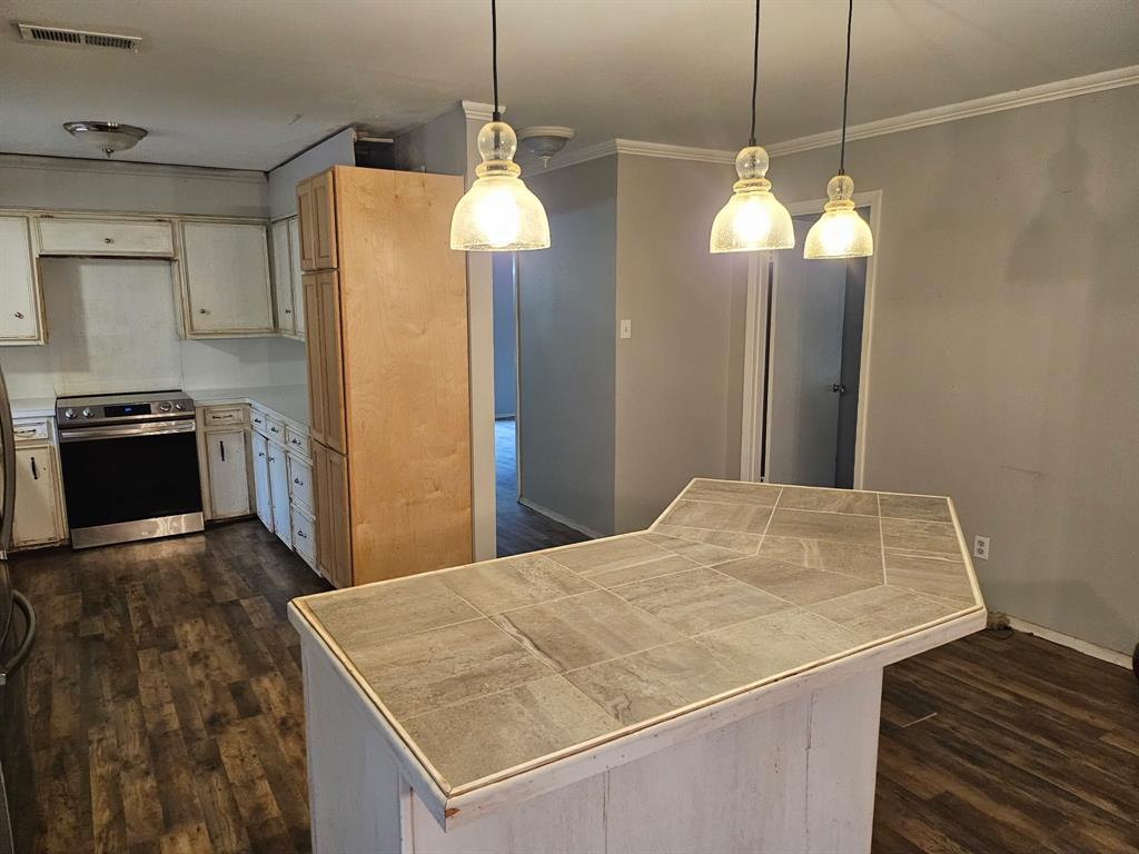 1088 Pheasant Road Gladewater, TX 75647 - Photo 4 of 31 a kitchen with a chandelier a sink and refrigerator