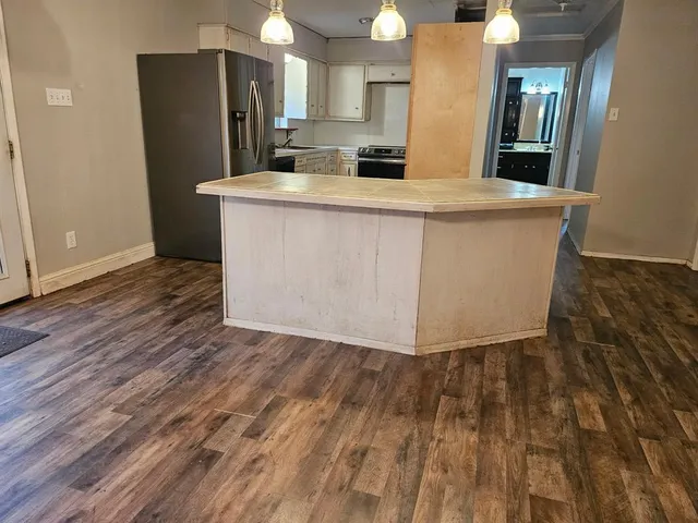 a view of a kitchen with wooden floor