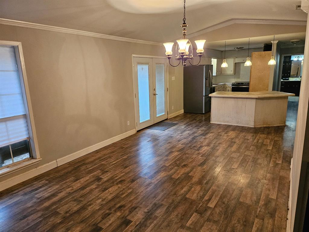 1088 Pheasant Road Gladewater, TX 75647 - Photo 6 of 31 a view of a big room with wooden floor and kitchen view