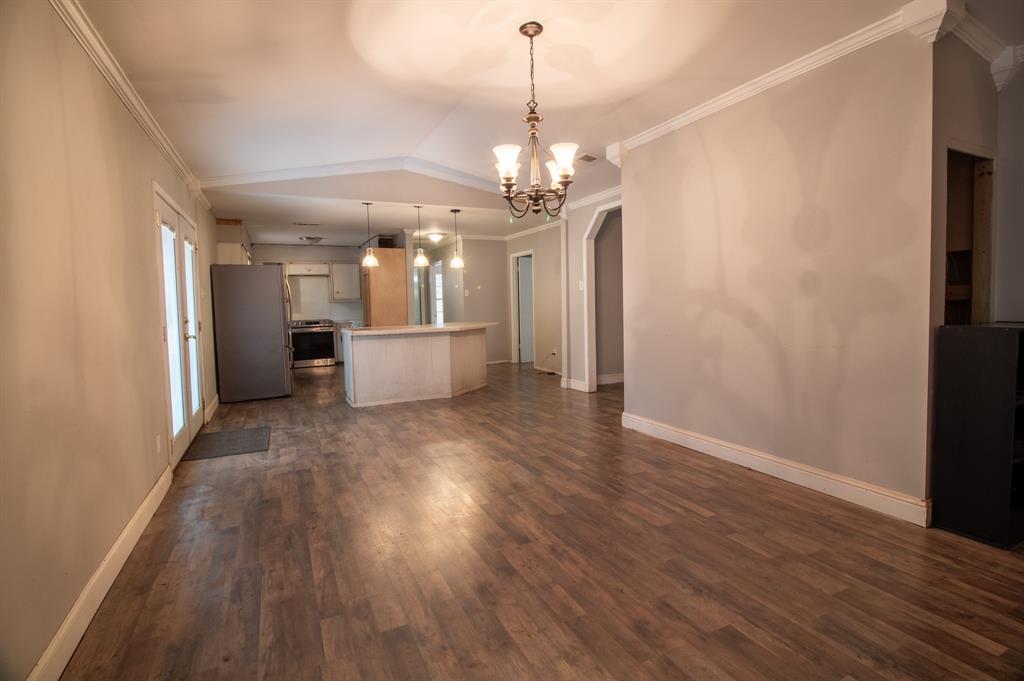 1088 Pheasant Road Gladewater, TX 75647 - Photo 10 of 31 a view of a big room with wooden floor and windows