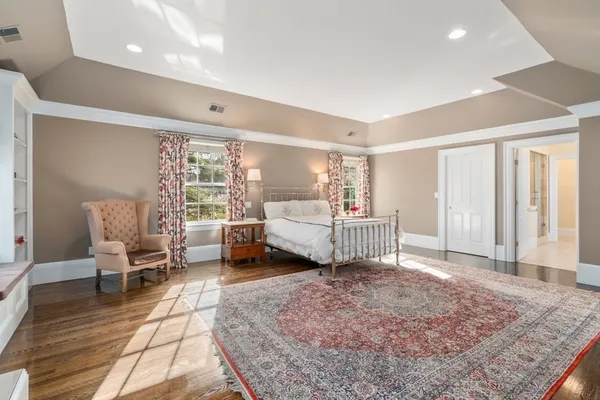 a bedroom with a bed and large window