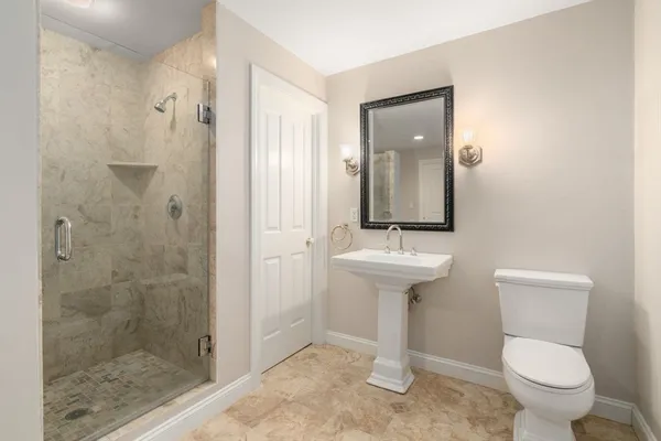 a bathroom with a sink toilet and shower