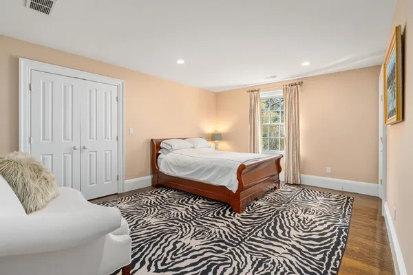 a bedroom with a large bed and a couch