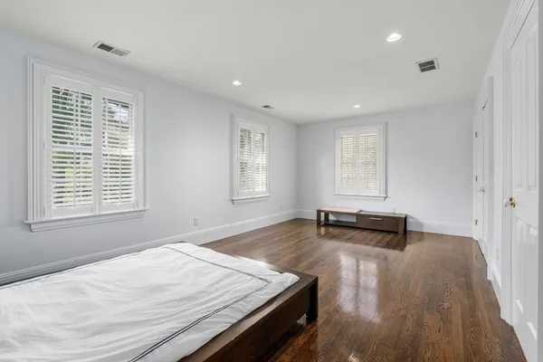 a view of a room with wooden floor and furniture