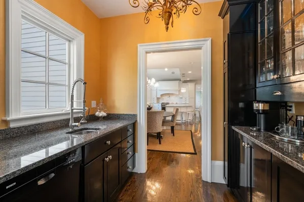 a kitchen with stainless steel appliances granite countertop a sink stove and cabinets