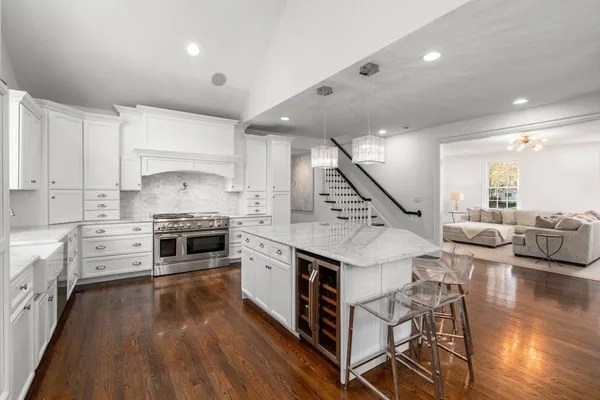 a kitchen with stainless steel appliances a stove top oven and cabinets