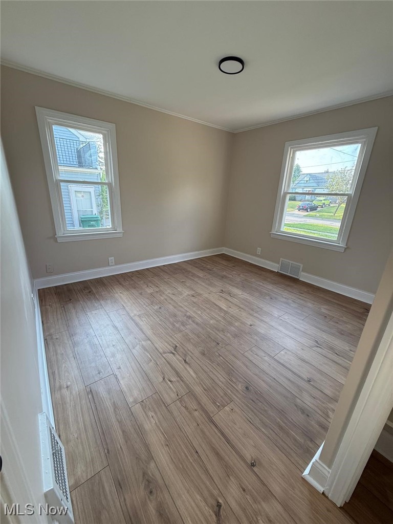 15410 Turney Road Maple Heights, OH 44137 - Photo 24 of 46 Spare room with light wood-type flooring and ornamental molding