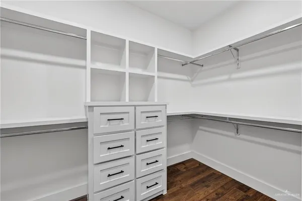 a view of walk in closet with empty racks