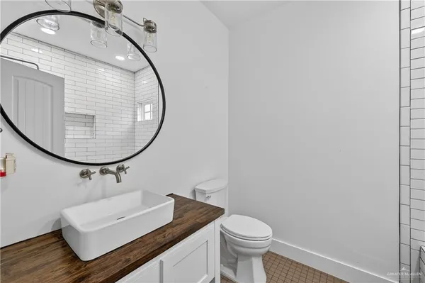 a bathroom with a sink mirror and toilet
