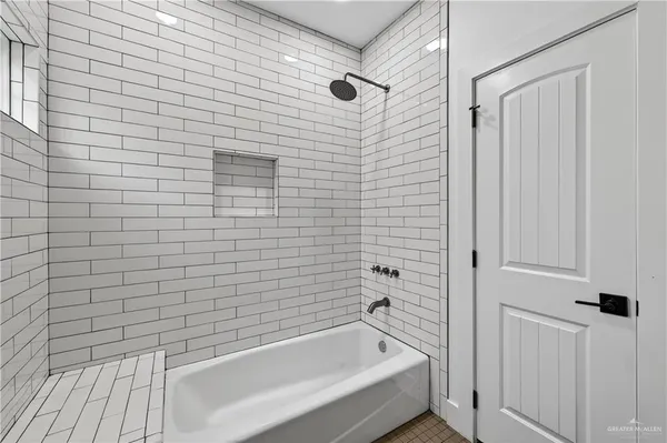 a bathroom with a bathtub and shower