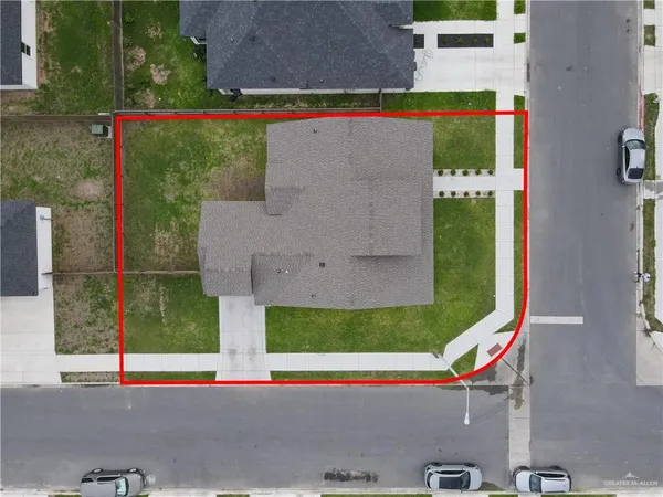an aerial view of a house with a yard and a garden