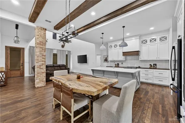 a kitchen with a table chairs sink and cabinets