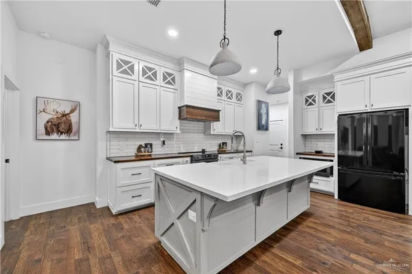 a kitchen with stainless steel appliances a stove a sink and a refrigerator