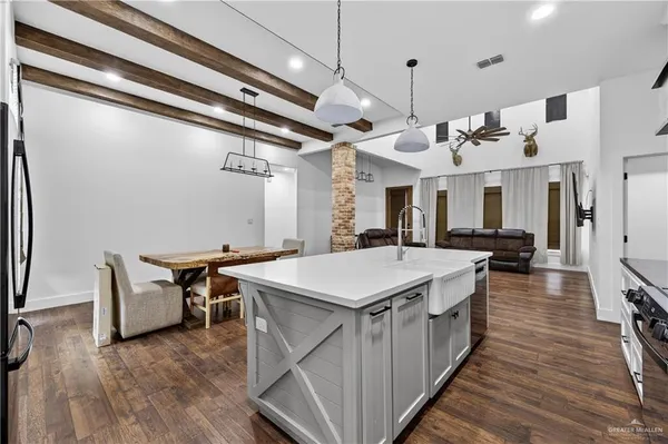 a large kitchen with a table and chairs