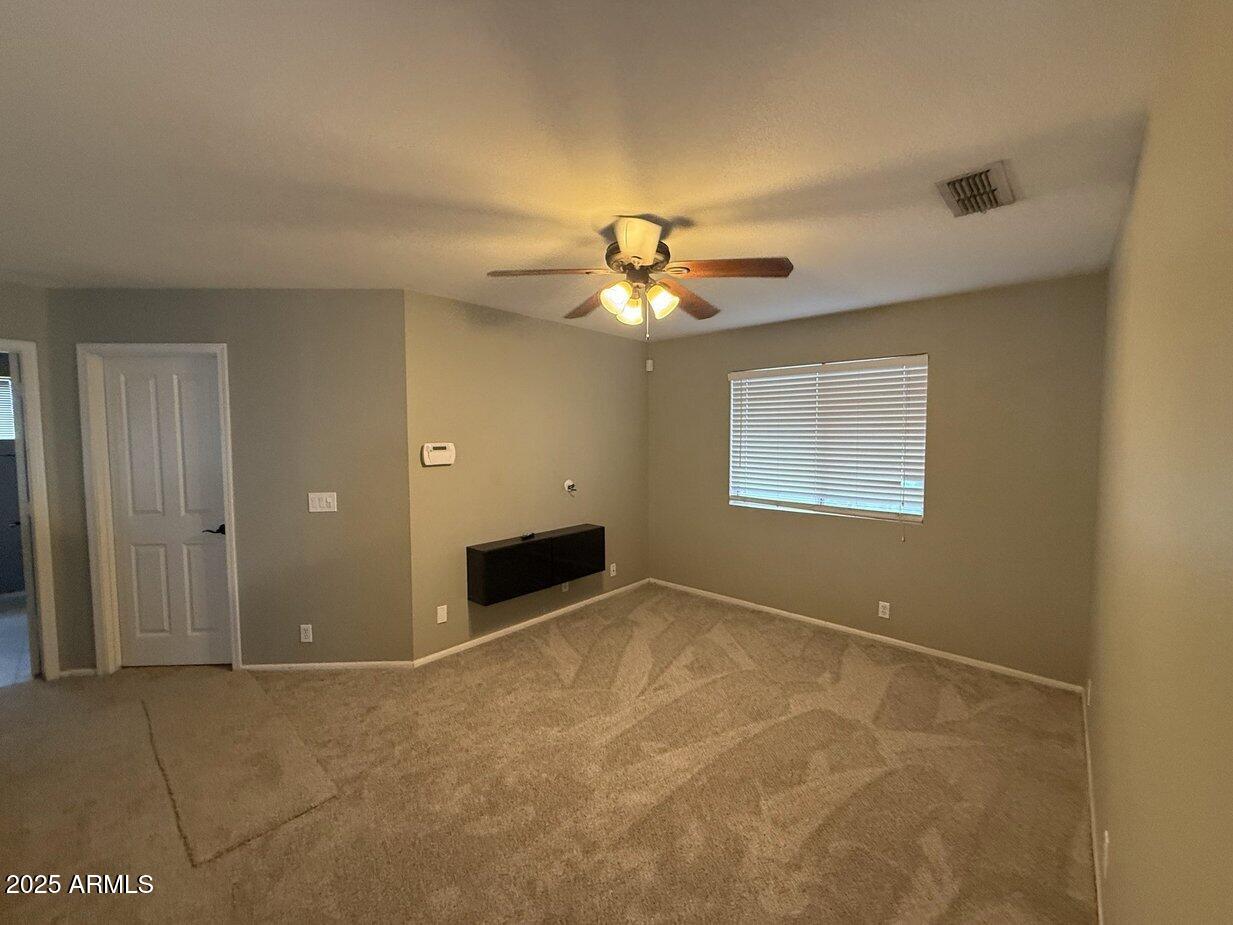 6079 West Irma Lane Glendale, AZ 85308 - Photo 15 of 33 an empty room with windows and fan