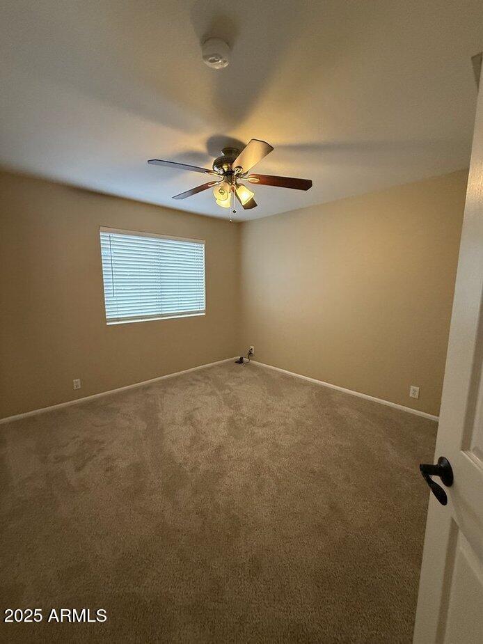 6079 West Irma Lane Glendale, AZ 85308 - Photo 20 of 33 an empty room with windows and fan