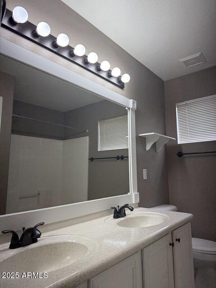 6079 West Irma Lane Glendale, AZ 85308 - Photo 22 of 33 a bathroom with a sink and a mirror