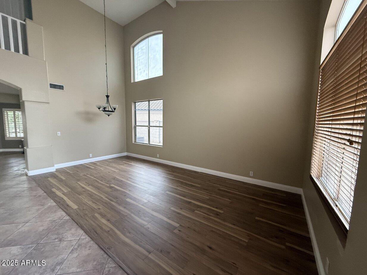 6079 West Irma Lane Glendale, AZ 85308 - Photo 3 of 33 wooden floor in an empty room with a window