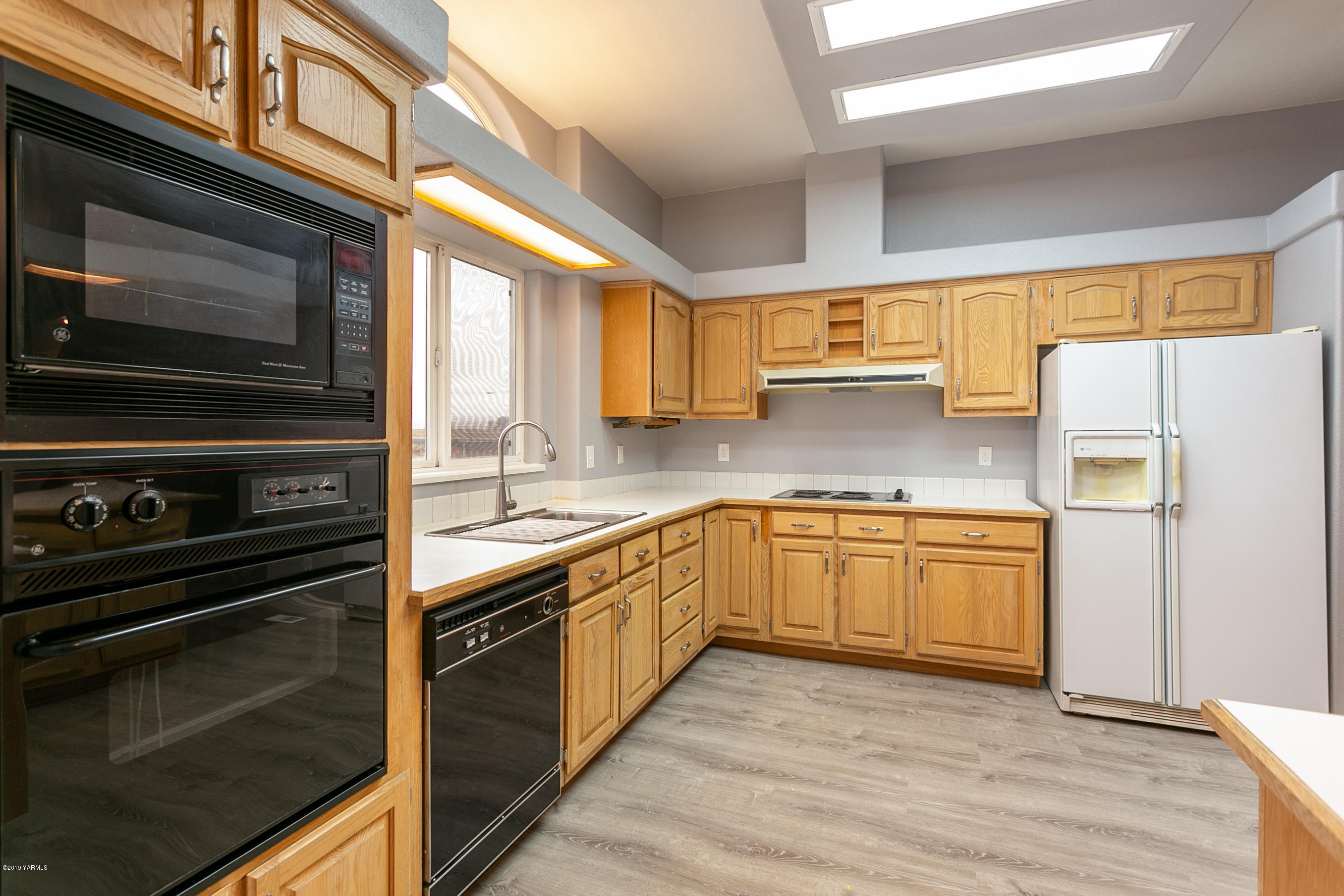 1361 Highschool Road Mabton, WA 98935 - Photo 7 of 24 a kitchen with a refrigerator stove and sink