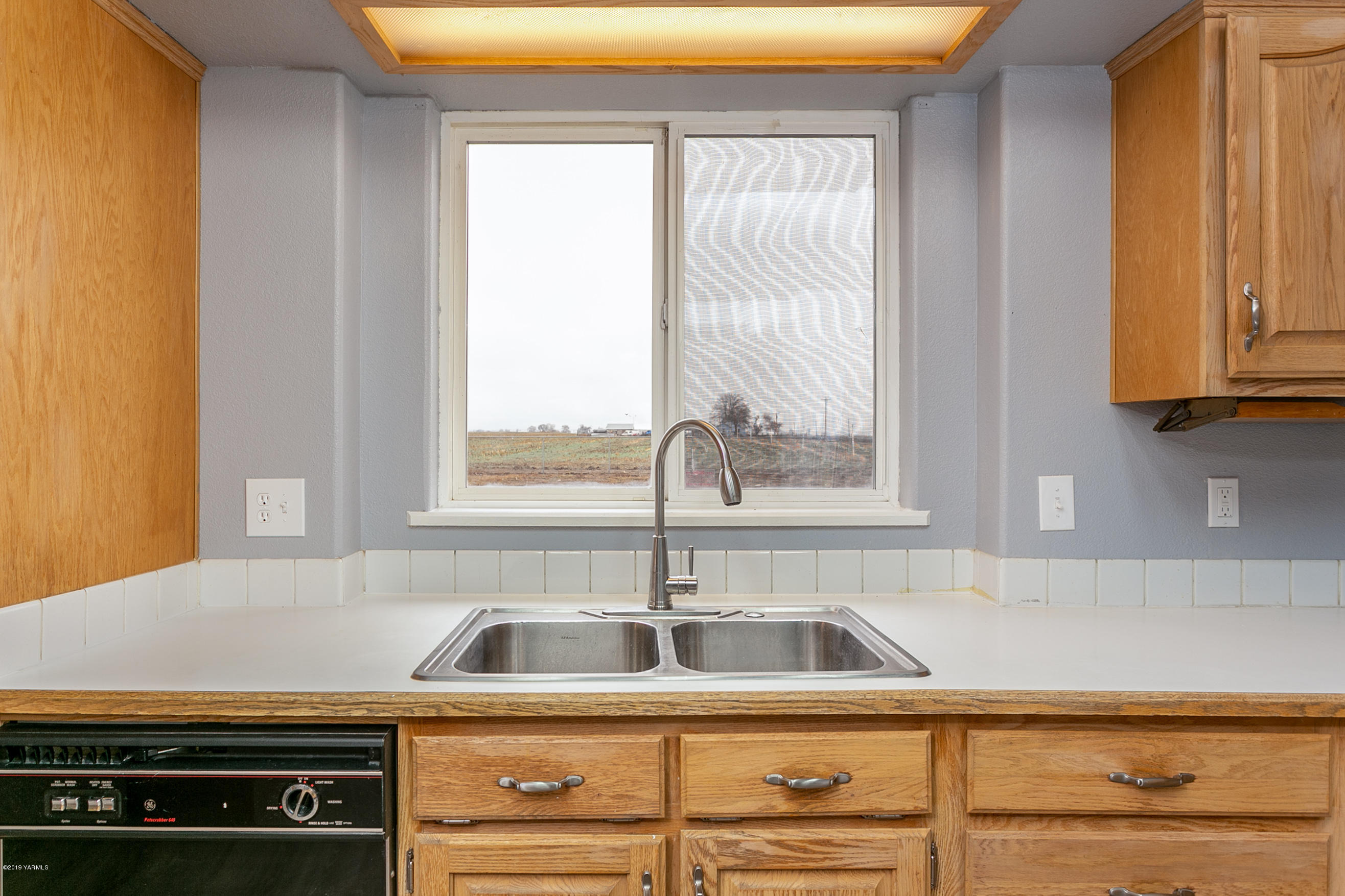 1361 Highschool Road Mabton, WA 98935 - Photo 8 of 24 a kitchen with a sink and cabinets
