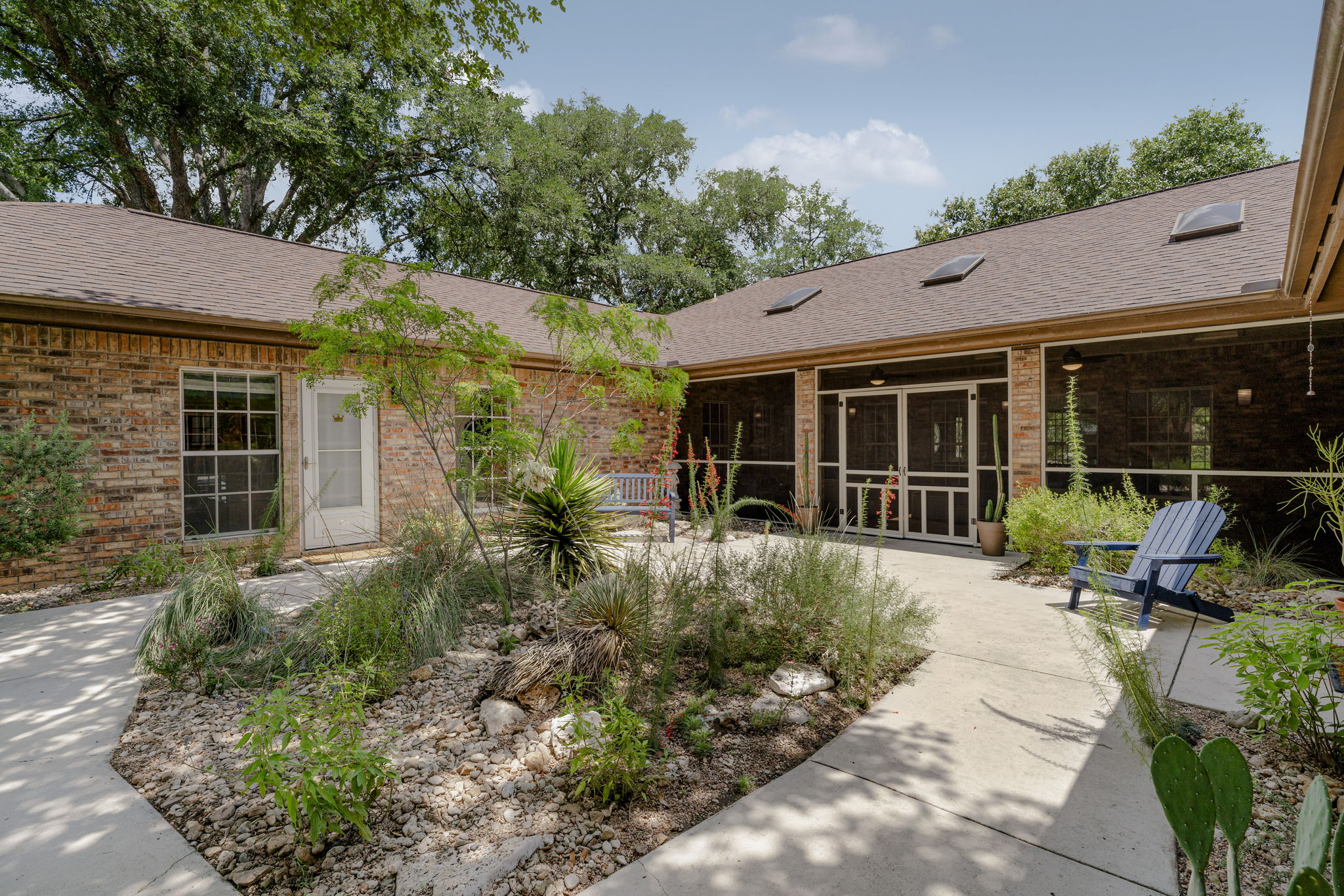 400 Hackberry Street Lockhart, TX 78644 - Photo 31 of 40 A well-maintained brick exterior property features a screened patio, inviting courtyard landscaping, and convenient skylights.
