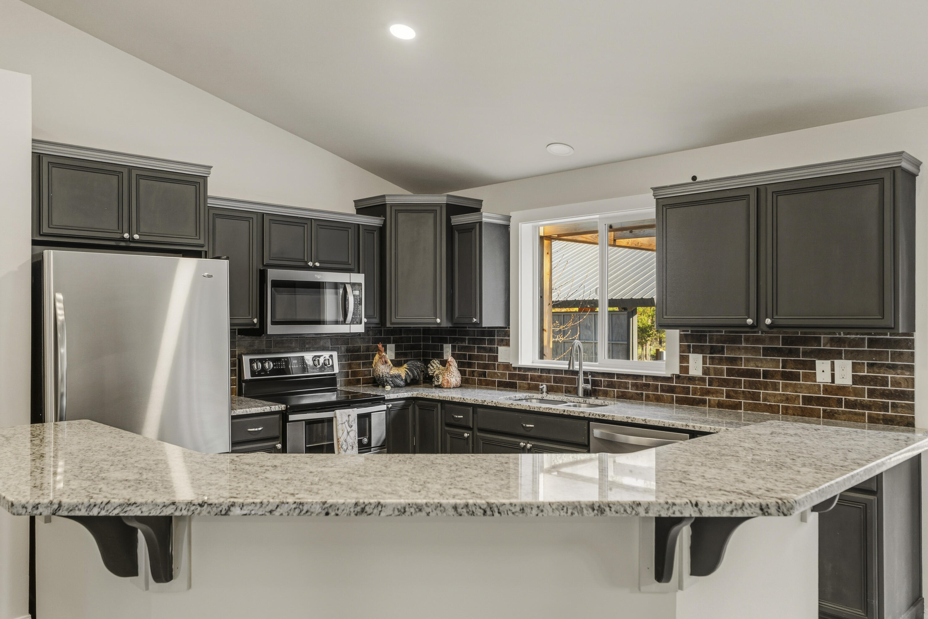 16050 Dick Road La Pine, OR 97739 - Photo 18 of 59 a kitchen with stainless steel appliances granite countertop a sink refrigerator and microwave